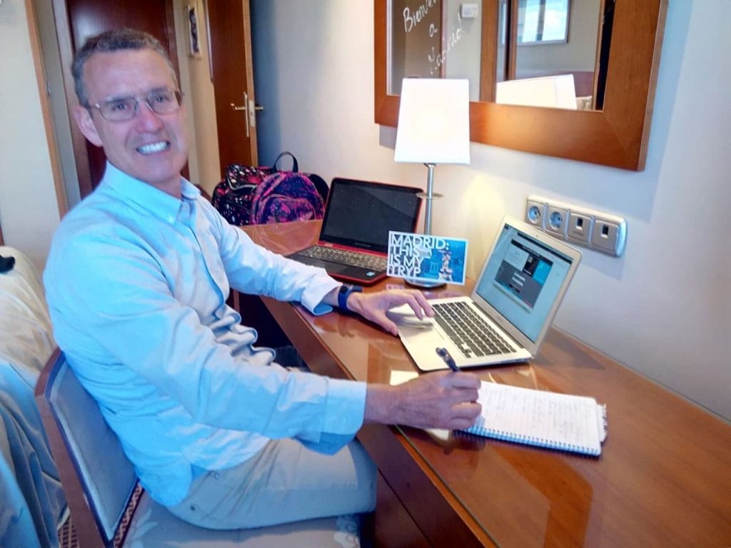 Doctor working on his online business on laptop on desk